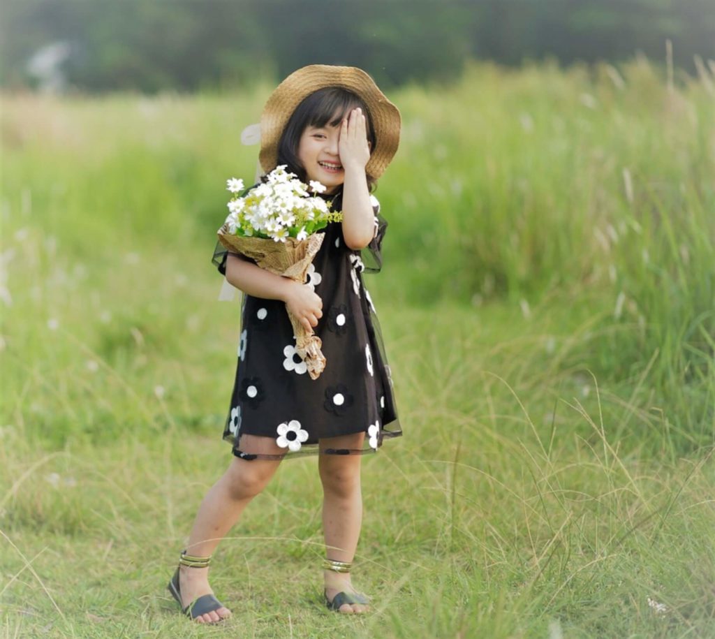 sydney young asian girl with flowers and hat covering one eye in multifocal contact lenses or orthokeratology for myopia control