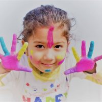 sydney nepalese child using misight or orthokeratology with paint all over hands