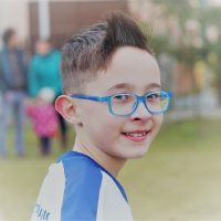 sydney young boy in extended focus multifocal glasses for myopia control blue frame alternative to orthokeratology